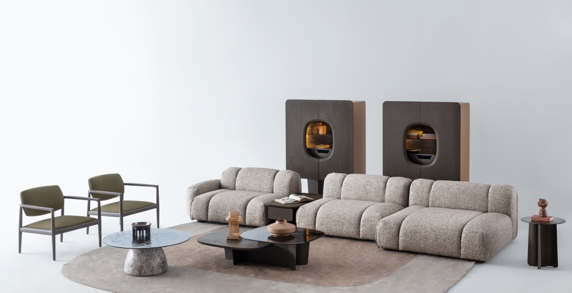Stylish living area with curved sectional sofa and sculptural accessories.
