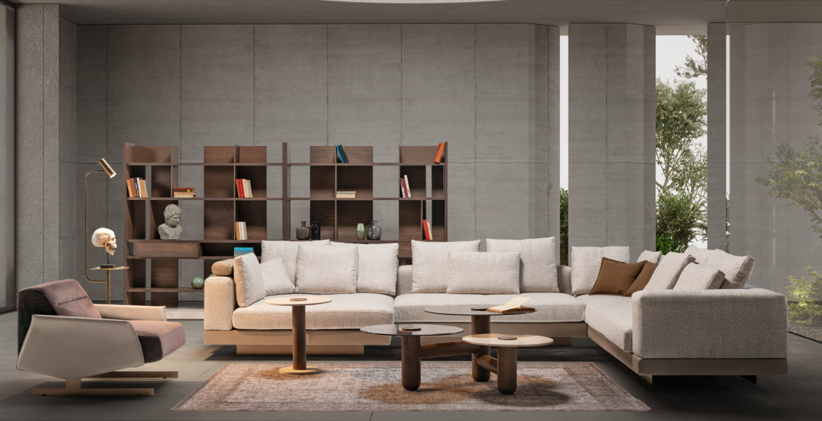 Elegant interior with beige sectional sofa and sculptural décor pieces.