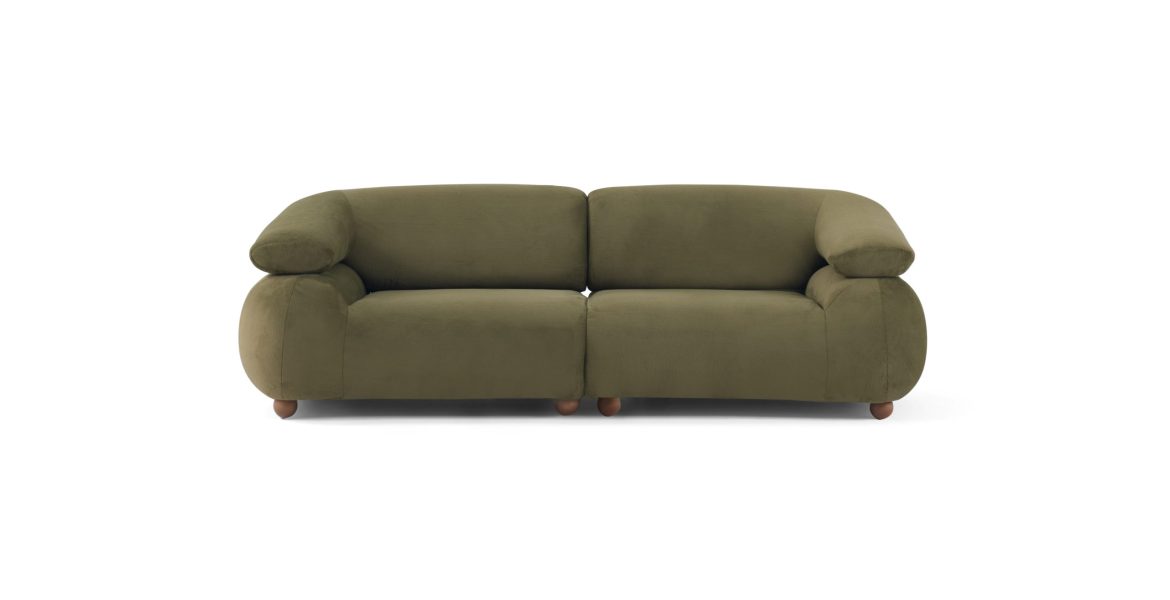 Modern home interior featuring green sofa, white sofa, and warm wooden accents.