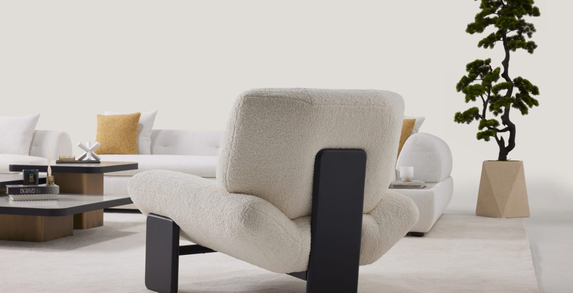 Warm-toned interior with corner sofa and sculptural accessories.