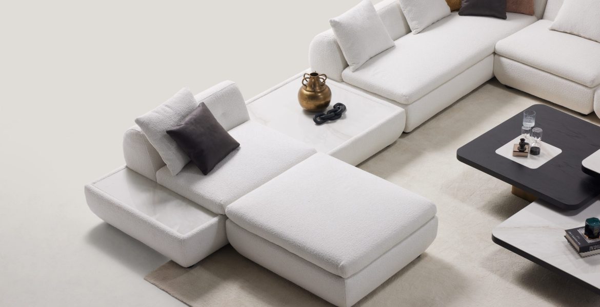 Living space showcasing modular corner sofa and decorative coffee tables.