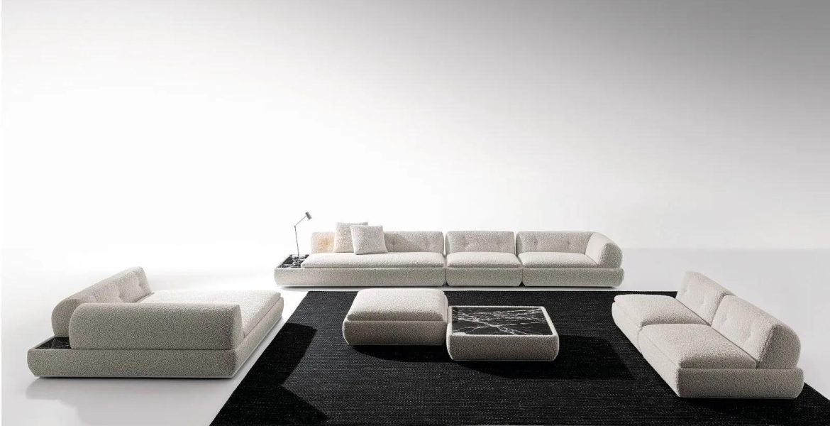 Calm interior with beige sofa, lounge chairs, and sculptural décor.