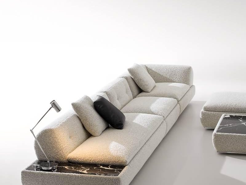 Living space showcasing minimalist sofa set and warm decorative lighting.