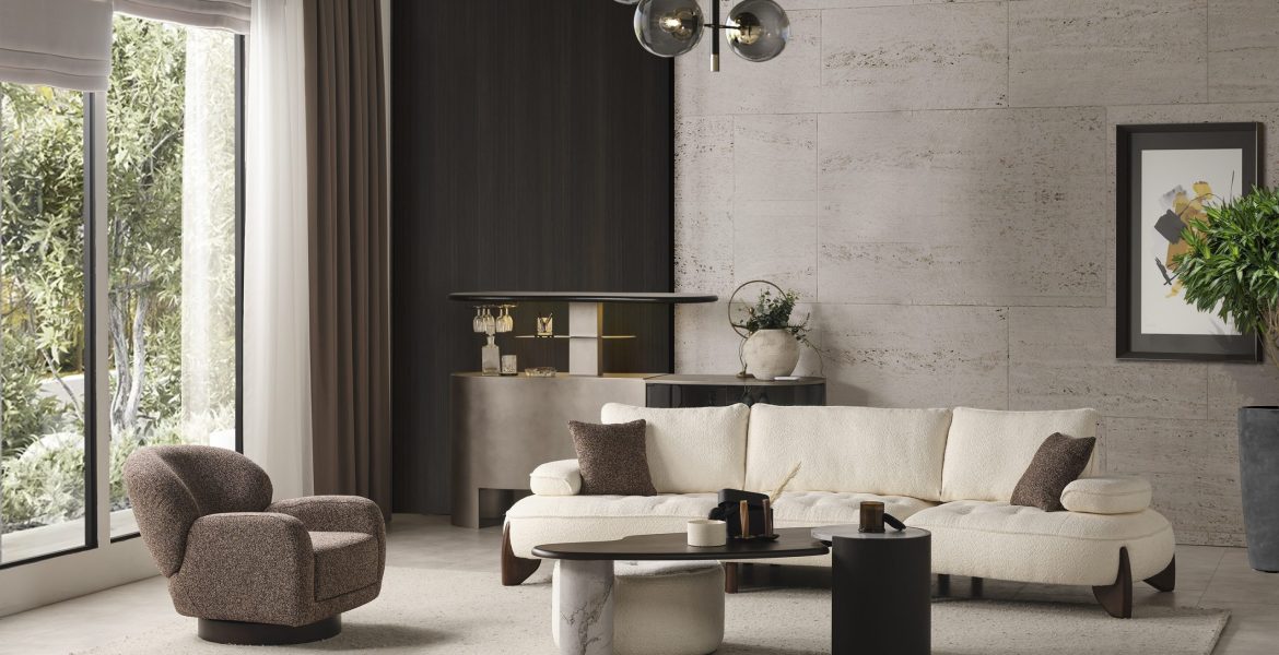 Stylish living area with cream sectional sofa and brown accent pillows.