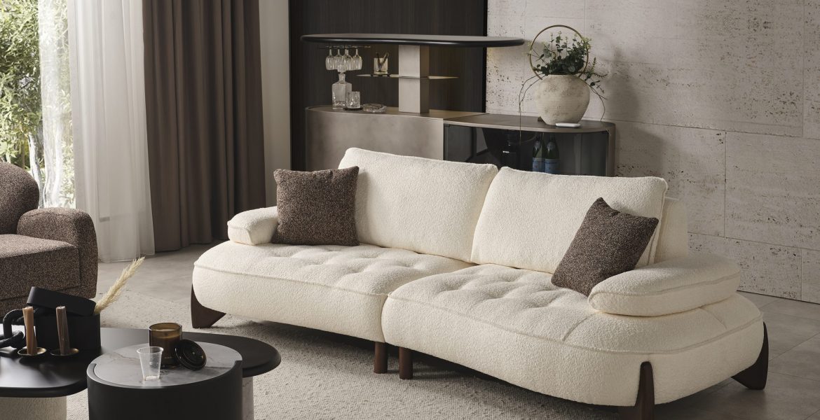 Modern space with sofa set, armchair, and tall indoor plant.