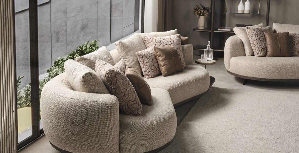 Living space with neutral sectional sofa and sculptural décor pieces.
