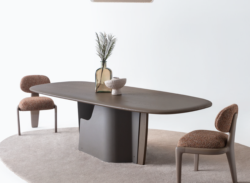 Minimalist dining table with smooth wooden top and dark base
