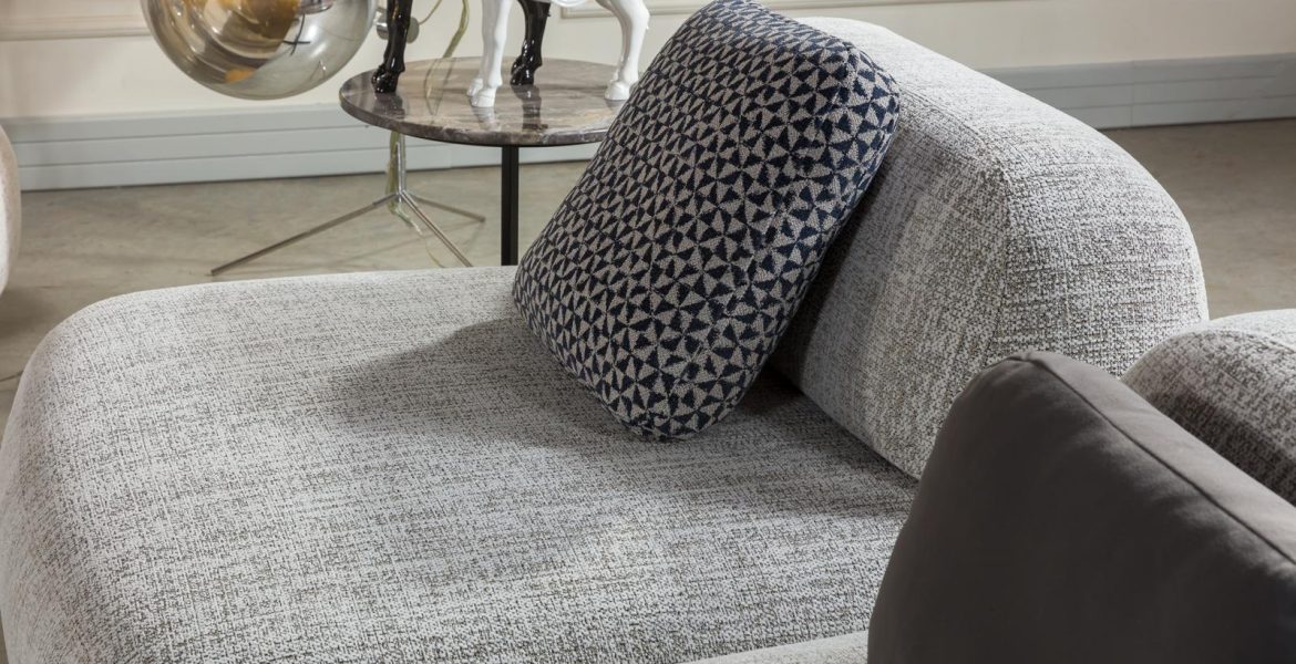 Genesis L-shape Sofa set featuring sofa and tables.