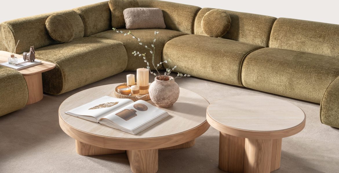 Beige swivel armchair with curved backrest.