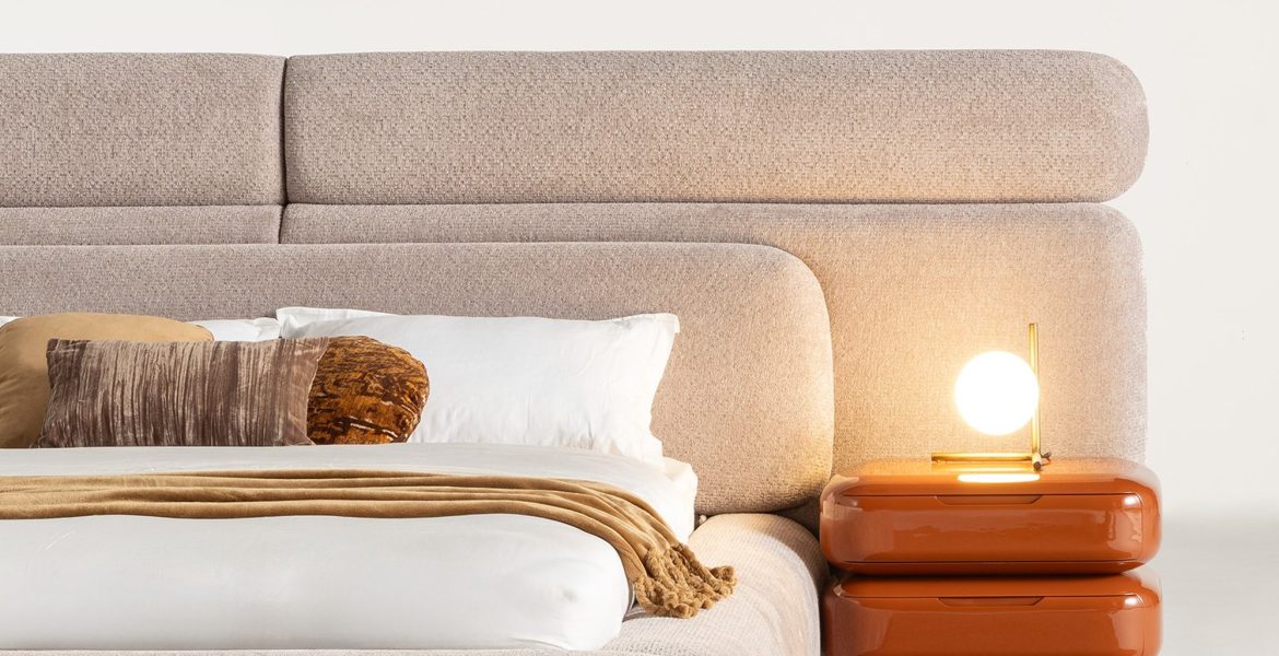 Bed paired with glossy orange nightstands.
