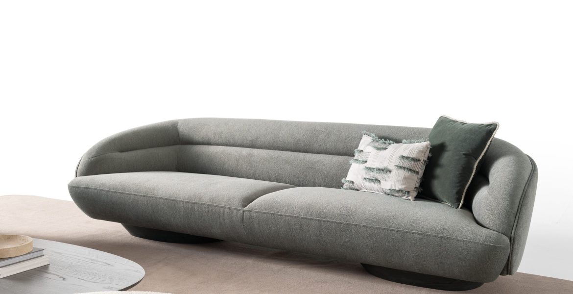 Curved beige sofa with soft upholstery.