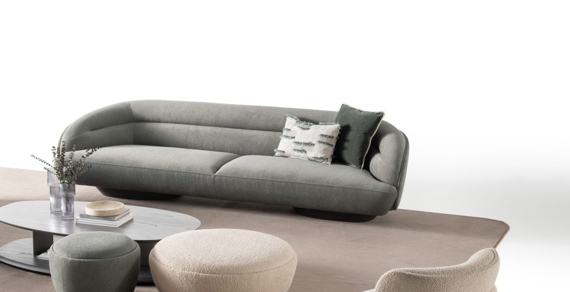 Mustard armchair with rounded backrest.