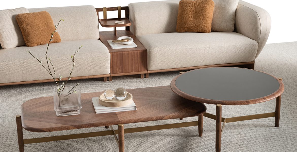Beige sofa with wooden base and soft cushions.