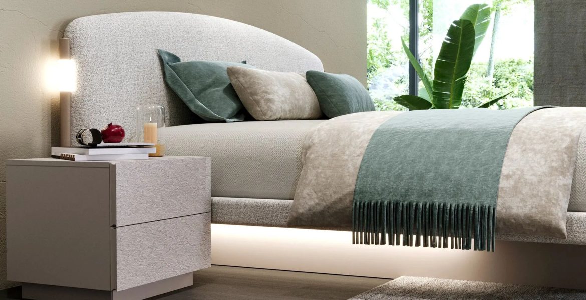 Upholstered bed with curved headboard and soft fabric.
